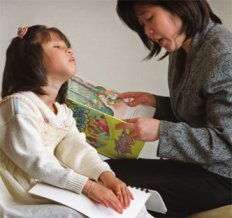 Child reading Braille